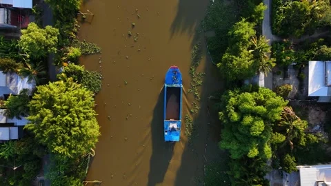 Top-down view of a boat moving along a silt-filled canal. Stock Footage 340548149