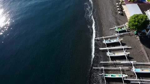 Top down view on boats on black sand beach Stock Footage 161782742