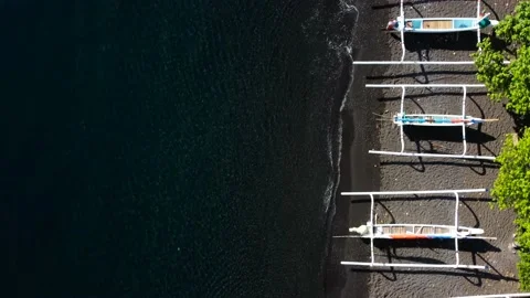 Top down view on boats on black sand beach Stock Footage 162568396