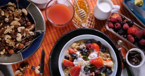 Top down view of a breakfast of pancakes with berries and dry fruits Video stock 74067344