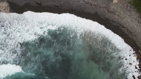 Top down view of breaking ocean waves on dark shore Stock Footage 336022988