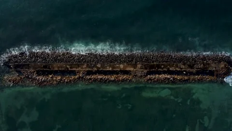Top down view on breakwater a far from the beach Stock Footage 153348940