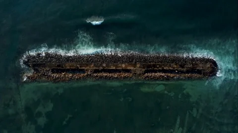Top down view on breakwater a far from the beach Stock Footage 154025917