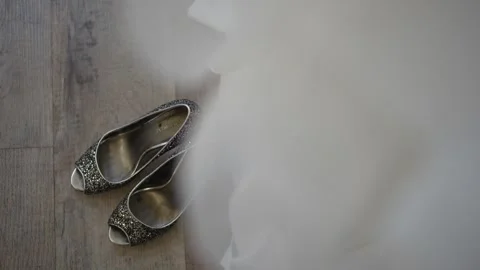 Top down view of bridal shoes with the wedding dress in the shot Stock Footage 278047347