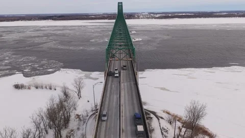 Top down view of bridge cutting through frozen river Stock Footage 329395431