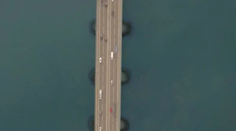 Top down view of the bridge with intense traffic over water. Aerial shot Video stock 66719973