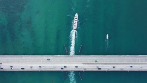 Top down view on a bridge over the scenic bay. 4K aerial of road with traffic 스톡 동영상 134480063