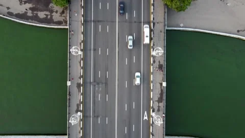 Top-down view on a brigde over green river with road on it. Highway on a bridge. Stock Footage 170421950