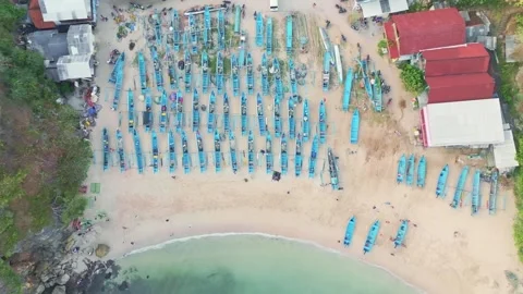 Top-down view captures numerous blue fishing boats arranged in orderly rows.. Stock Footage 341545468