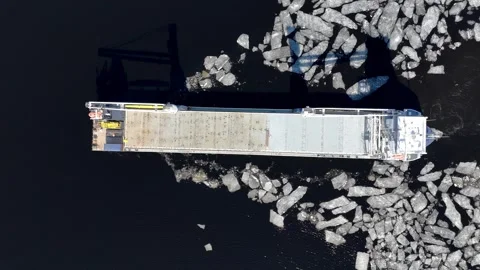 Top down view of cargo ship navigating through broken sea ice Stock Footage 335353093