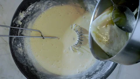 Top down view. Chef preparing thin pancake crepe batter. Stock Footage 303406677