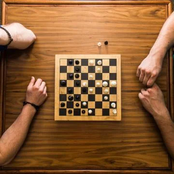 Top down view of chess game on a wooden table Stock Photos