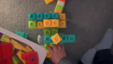 Top Down View of a Child Building With Colorful Construction Blocks Stock-Footage 330976877
