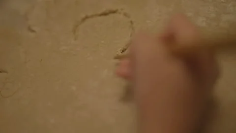 Top-down view of child's hand drawing in dough 스톡 동영상 336374638