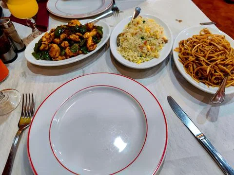 Top-down view of a Chinese restaurant table spread with noodles, rice and dishes 스톡 사진