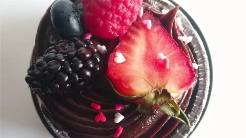 Top down view of chocolate mud cake with heartshaped sprinkles. Stock Footage 282464001