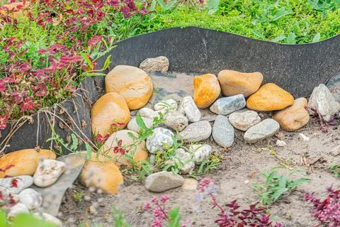 Top-down view of a circular garden with rock border, varying brown and beige  Stock Photos