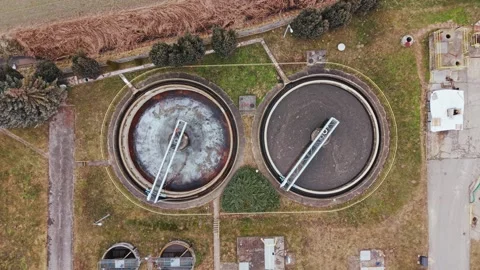 Top down view of circular sewage treatment tanks in Zduny, Poland, winter season Stock Footage 329191721
