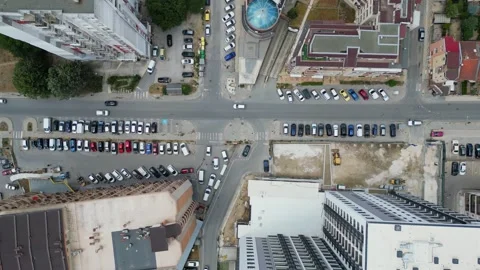 Top-down view of a city block with residential buildings, green spaces, and Stock Footage 281790050