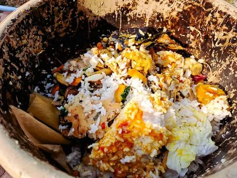 Top down view of a clay pot filled with kitchen scraps and food waste, read.. Stock Photos