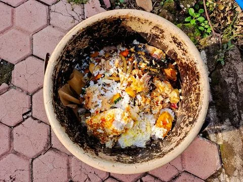 Top down view of a clay pot filled with kitchen scraps and food waste, read.. Stock Photos