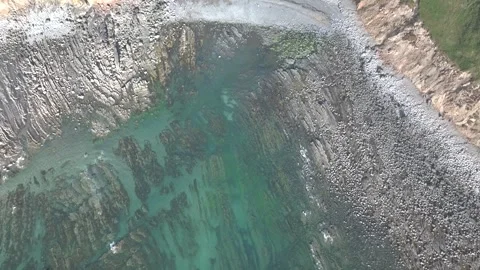 Top Down view of Cliffs and Farms over North Devon and Cornwall Coastpath Border Stock Footage 342452765