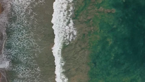 A top-down view of the coastline during a mild storm Stock Footage 305859634