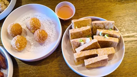 Top down view of coconut lava balls with crispy fried tofus appetizers meal with Video stock 318128311