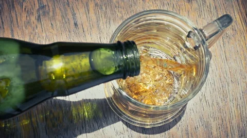 Top Down View of Cold Beer Pouring into Glass Mug with Frothy Foam 動画素材 342970029