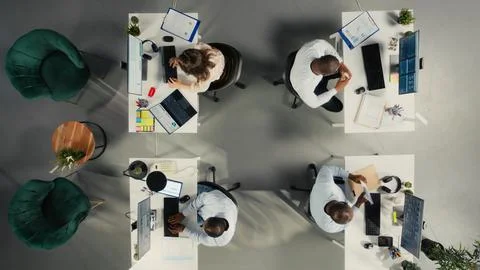 Top down view of colleagues sharing reports and visual data Stock Photos