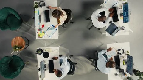 Top down view of colleagues sharing reports and visual data Stock Photos