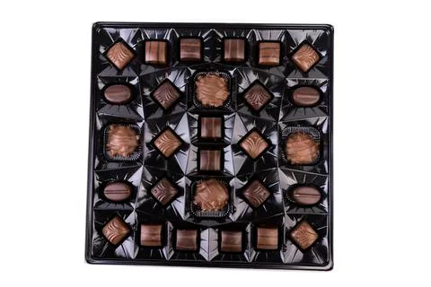 Top down view of collection of milk and dark striped chocolates in a shiny br Stock Photos