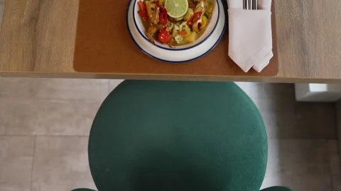 Top down view of colorful curry dish on wooden table Stock Footage 340887195