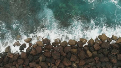 Top down view. The construction of stones to strengthen and protect the coast Stock Footage 112354449