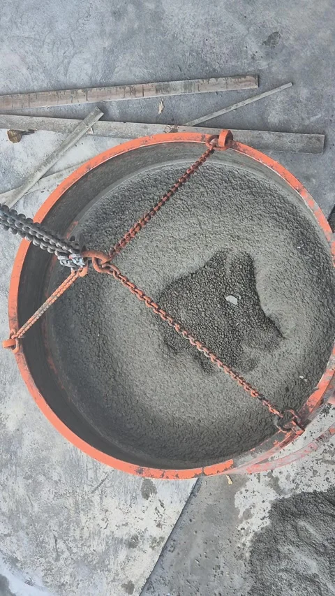 Top Down View of Crane Lifted Concrete Skip Filled with Wet Cement Stock Footage 340829857