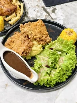 A top-down view of a crispy chicken chop Stock-Fotos