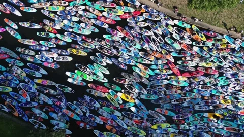 Top down view crowd of athletes on paddleboards Stock Footage 245346583