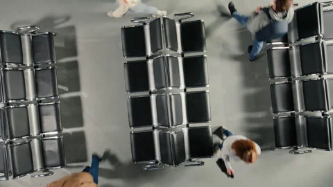 Top down view of crowd walking with trolleys and backpacks in busy airport Stock Footage 333649572