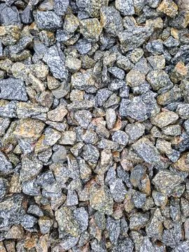 Top down view of crushed granite stone gravel rubble showing grey and brown.. Stock-Fotos