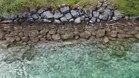 Top Down View of Crystal Clear Alpine Lake Water and Pebbled Bank Stock Footage 342312547