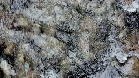 Top down view of a current, a still video showing water running over pebbles Stock Footage 160326723