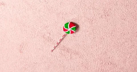 Top down view decorative candy toy red green spiral pattern on plush surface  Stock Photos