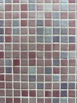 Top-down view of a decorative mosaic wall featuring small square tiles in a.. Stock Photos