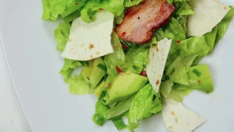 Top-down view of the delicious dish on the white plate. Fresh salad with lettuce Stock Footage 107447017