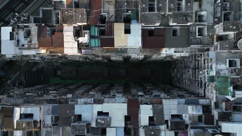 Top-down view of dense Hong Kong tenement block and deep courtyard Stock Footage 318317275