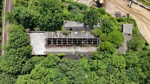 Top down view of a derelict railway building in west London with a collapsed Stock Footage 343465477