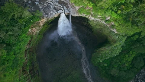 Top down view descending and spinning to Coban Sriti waterfall, Java, Indonesia 動画素材 252674999