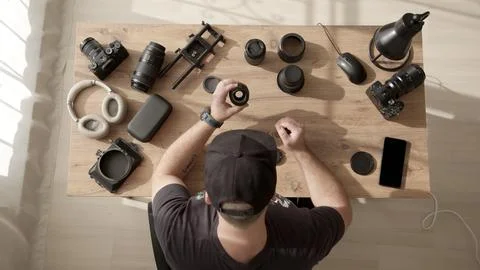 Top down view of desktop where videographer clean dust and dirt from equipment Stock Photos