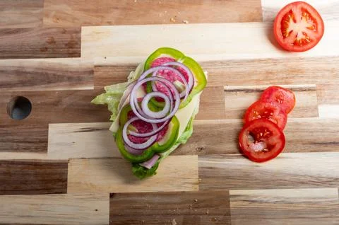 Top-down view of diced onion on wooden board  food preparation background Stock Photos