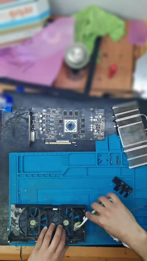 Top-down view of a disassembled high-end graphics card (GPU) on a blue magnetic 動画素材 333525371